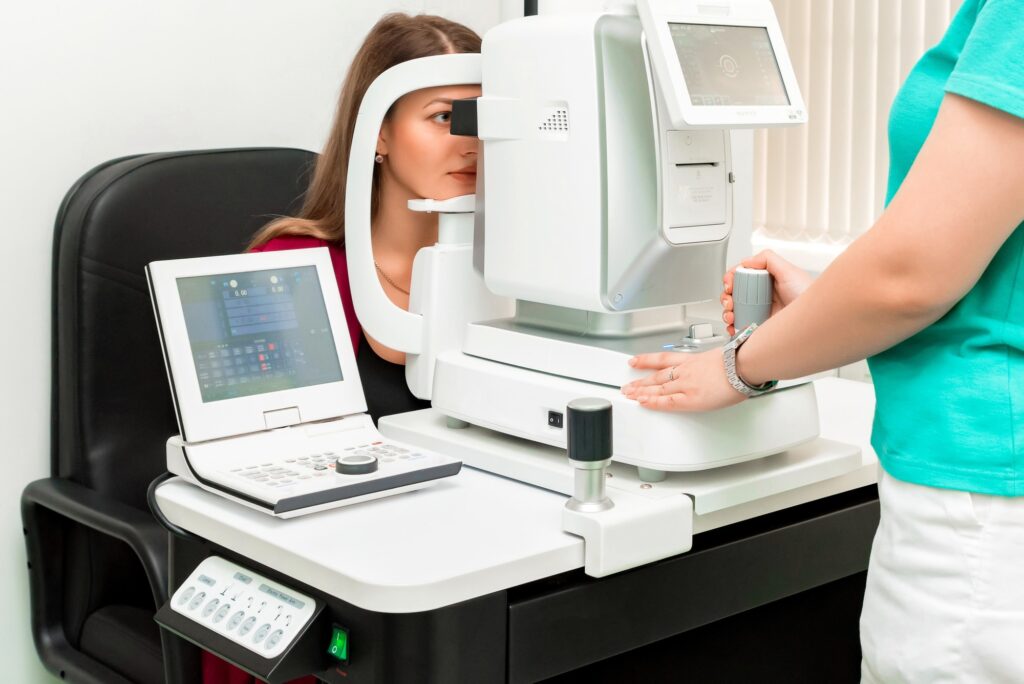 Woman having her eyes examined through a machine
