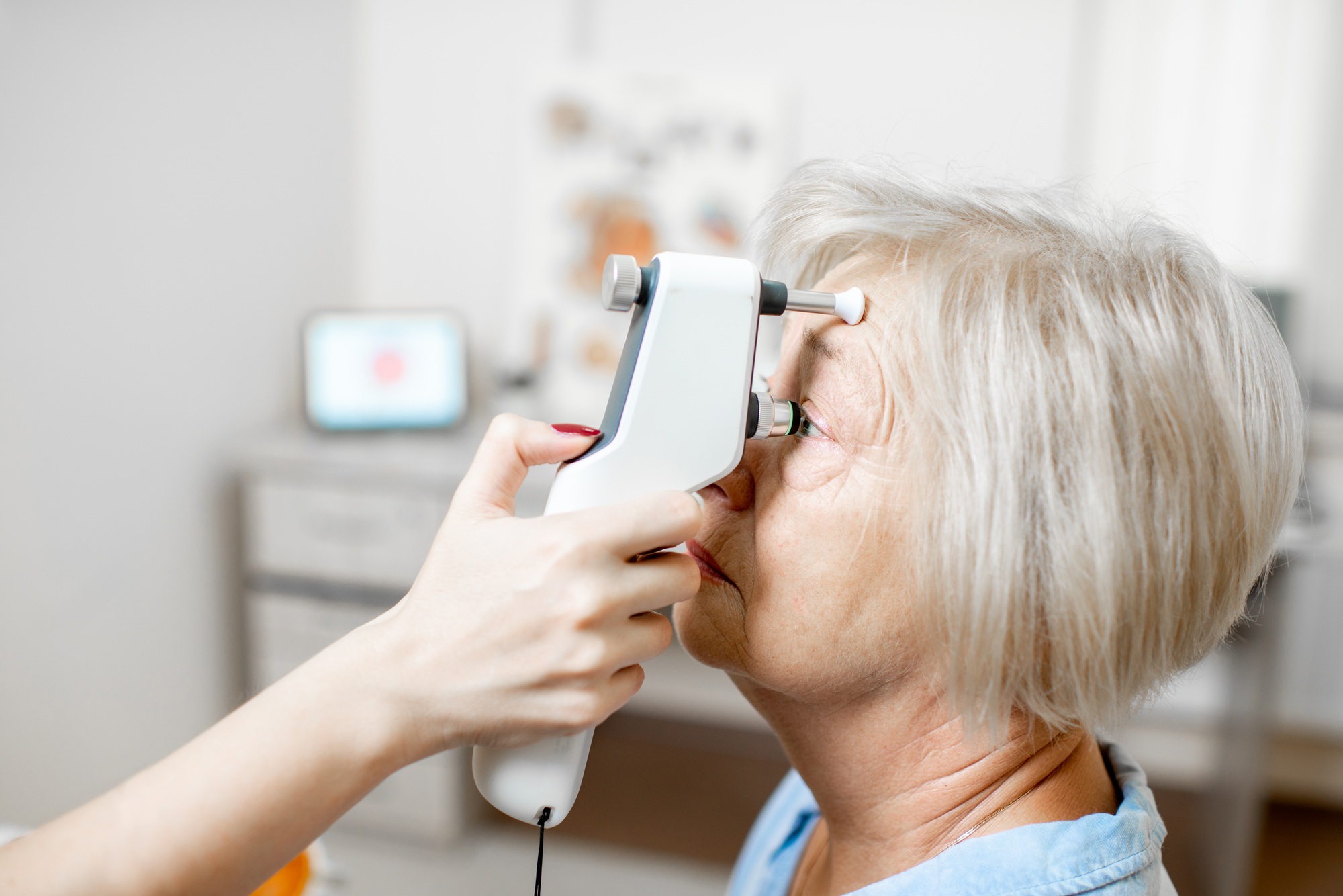 Senior woman getting her eye pressure examined by the doctor