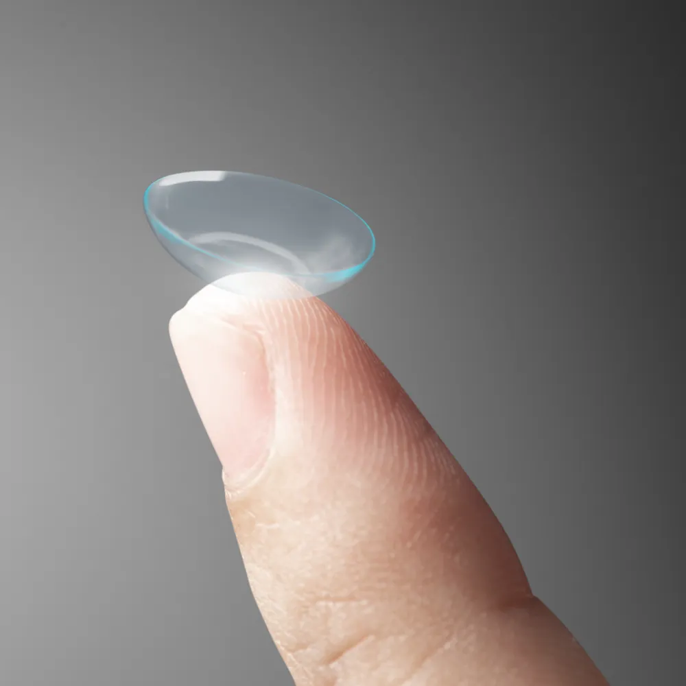contact lens held on the fingertips